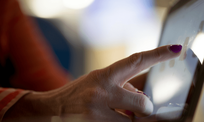 elderly hand touching computer screen